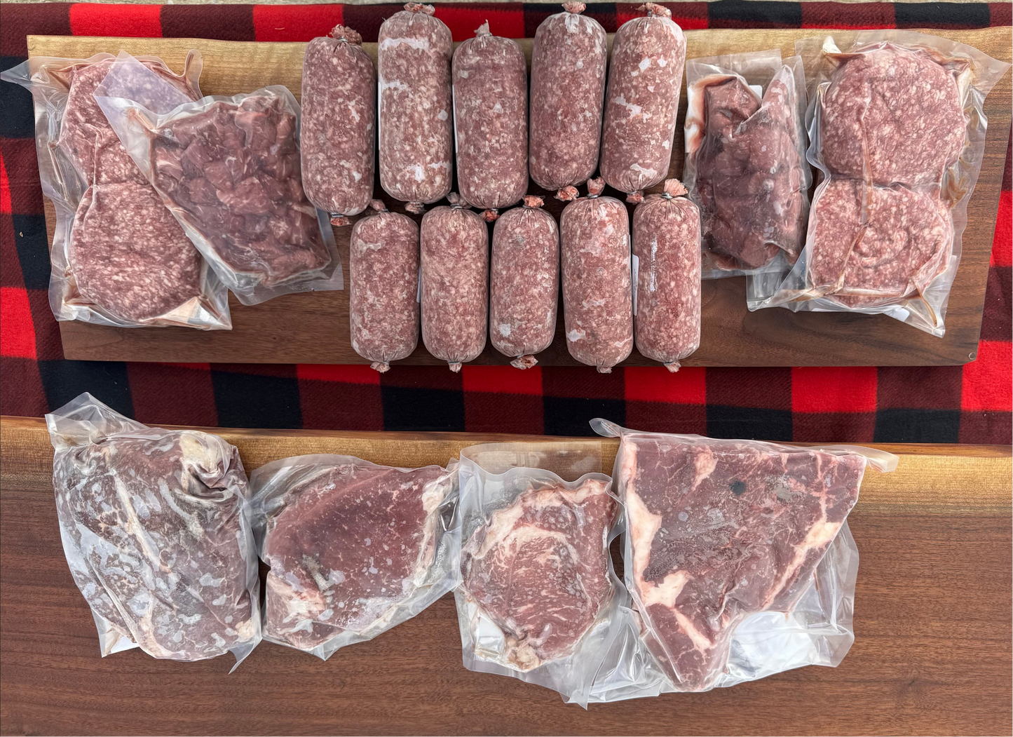 Assorted packaged meats on a wooden board with a red checkered tablecloth background